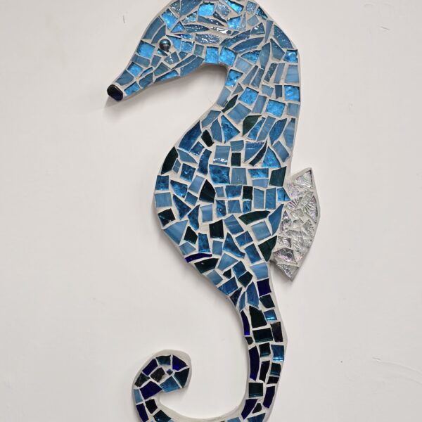 Mosaic of sea horse in blue galss.