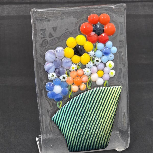 Glass creation of flowers in a green vase.
