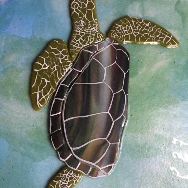 Brown turtle on pale blue / green background.