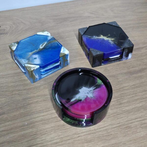 Three sets of glass coasters on table.