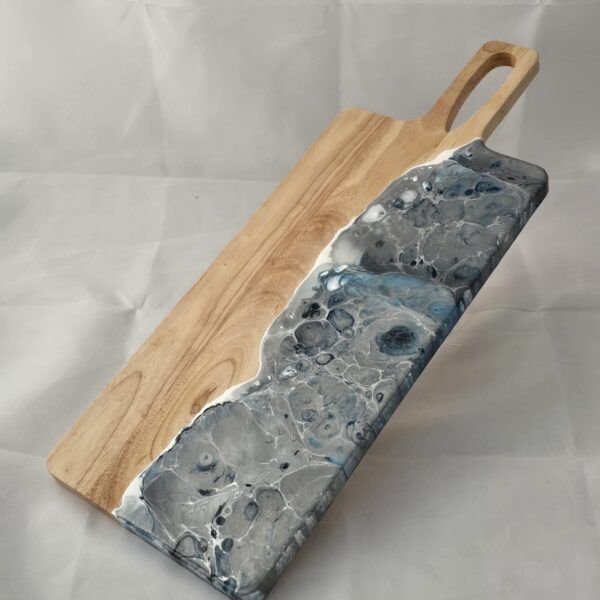 Silver fused glass on half of a cheeseboard.
